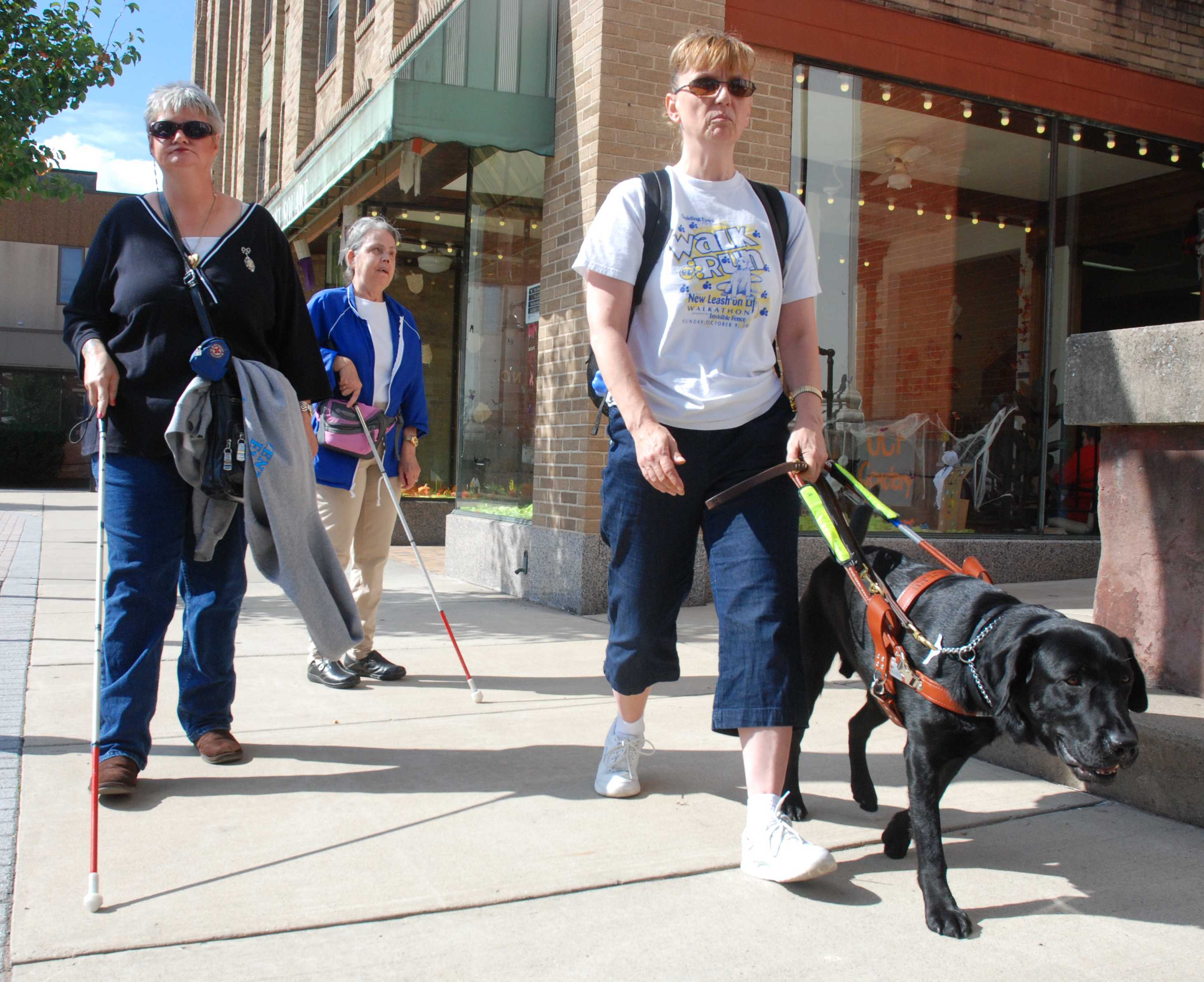 Three of our clients walking down the sidewalk in Lewistown, PA